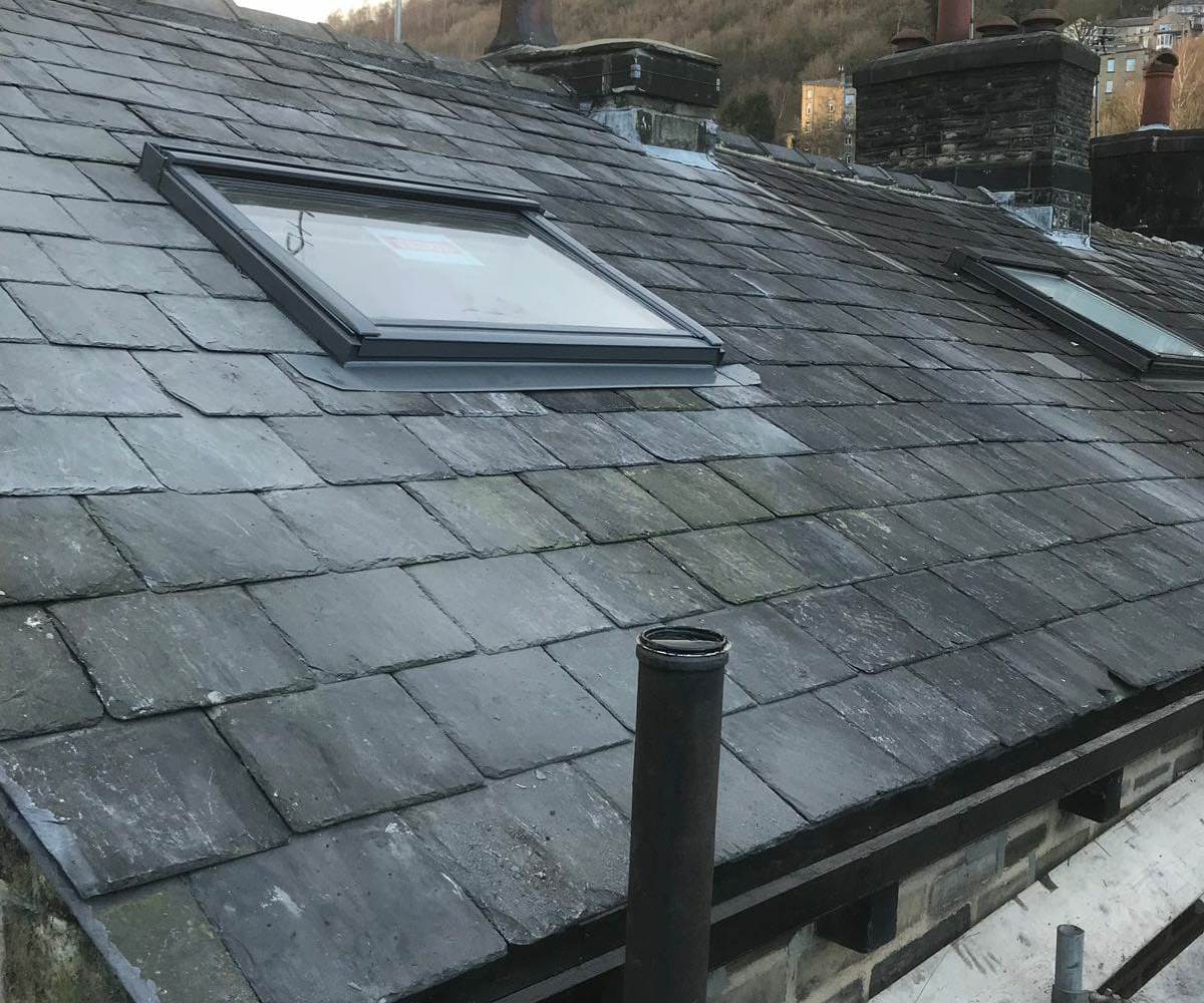 Newly fitted Velux roof windows flashed into a natural slate roof